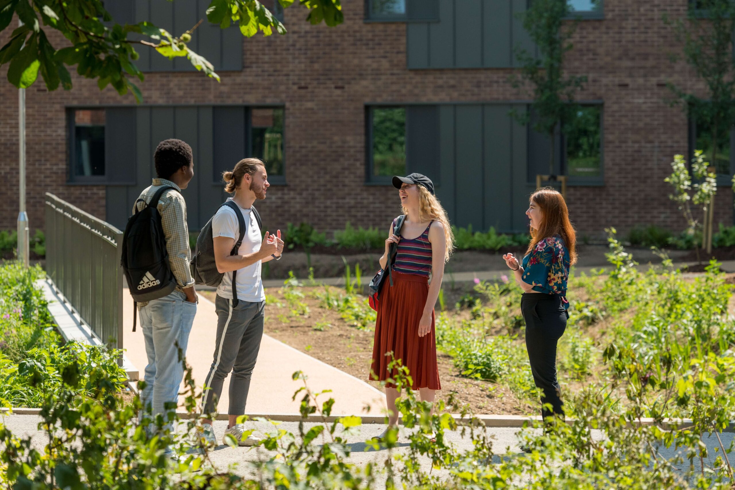 Four students standing outside a building